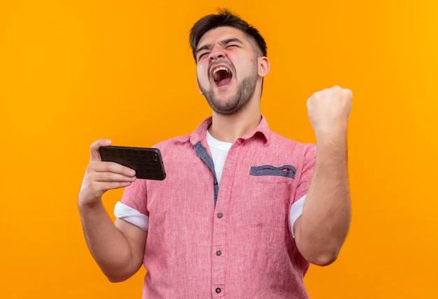 A person holding a smartphone, symbolizing the joy of victory