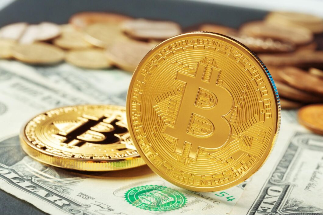 A Bitcoin coins on dollar banknotes